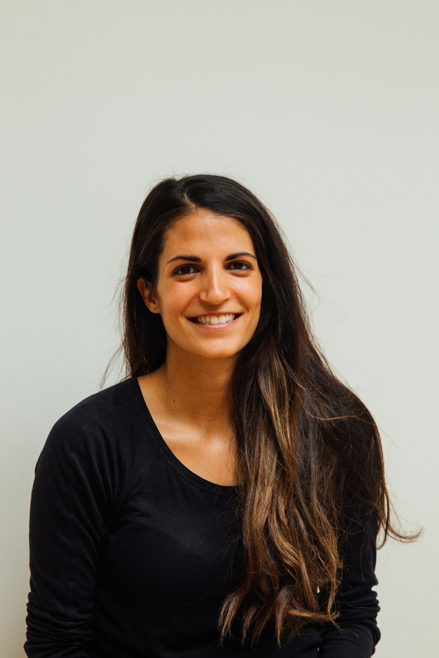 Portrait of a woman against a plain background